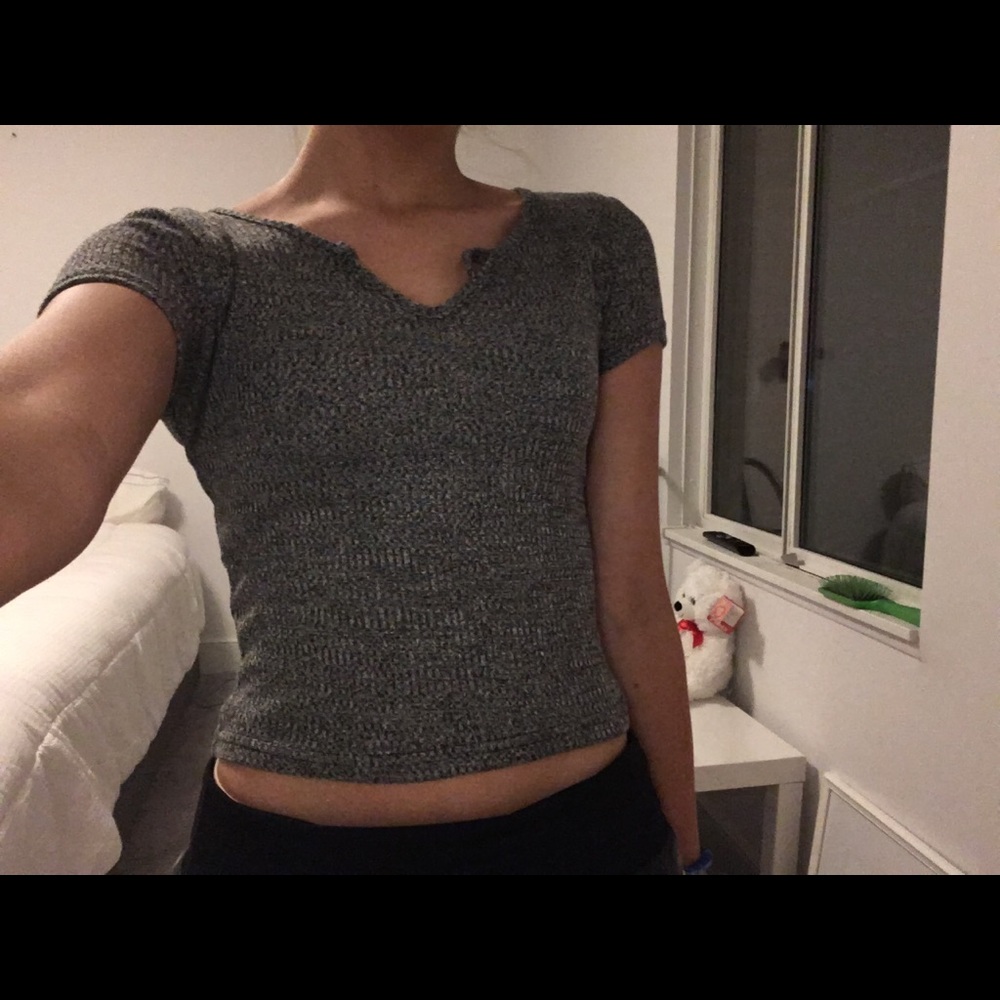 a grey silver and black crop top shirt